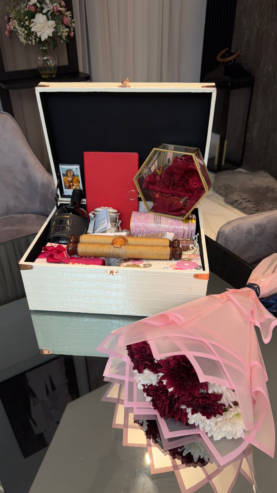 The Woman I Call Home open gift trunk with its curated contents and bouquet
